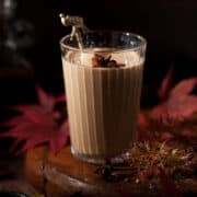 Glass of masala chai garnished with star anise