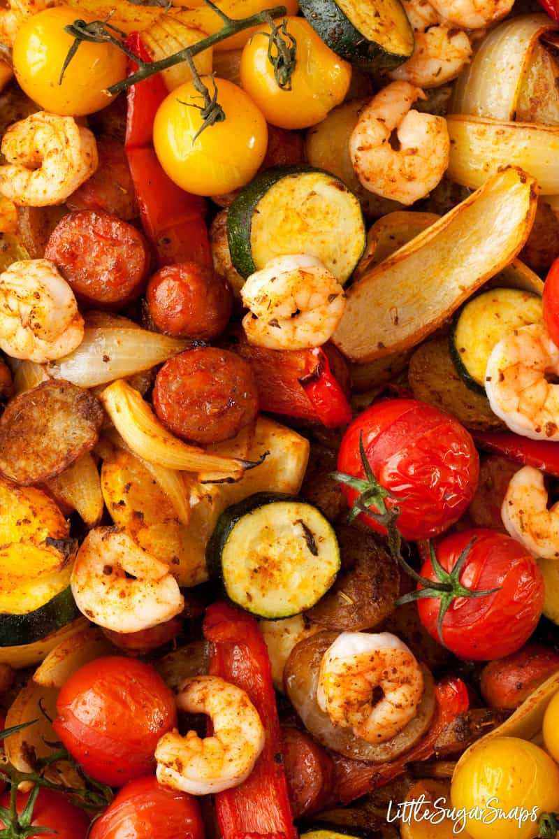 sheet pan chorizo and prawns with onion, tomatoes, red and yellow peppers and courgette