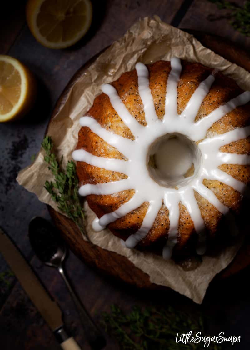 lemon drizzle bundt cake with white lemon icing dribbling down the sides.