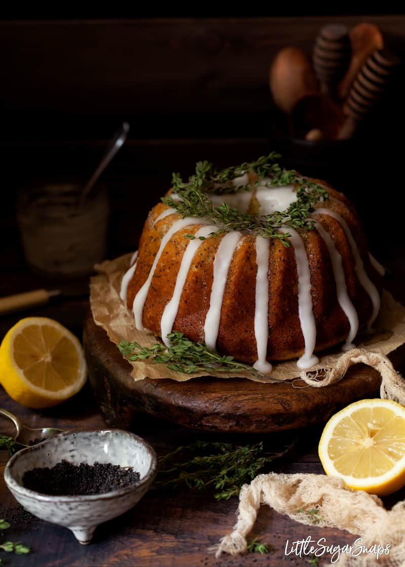 lemon and poppy seed sponge decorated with lemon glace icing and thyme leaves.