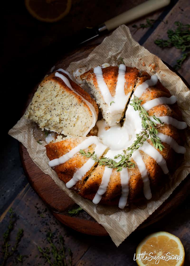 overhead view of lemon drizzle bundt cake being sliced up.