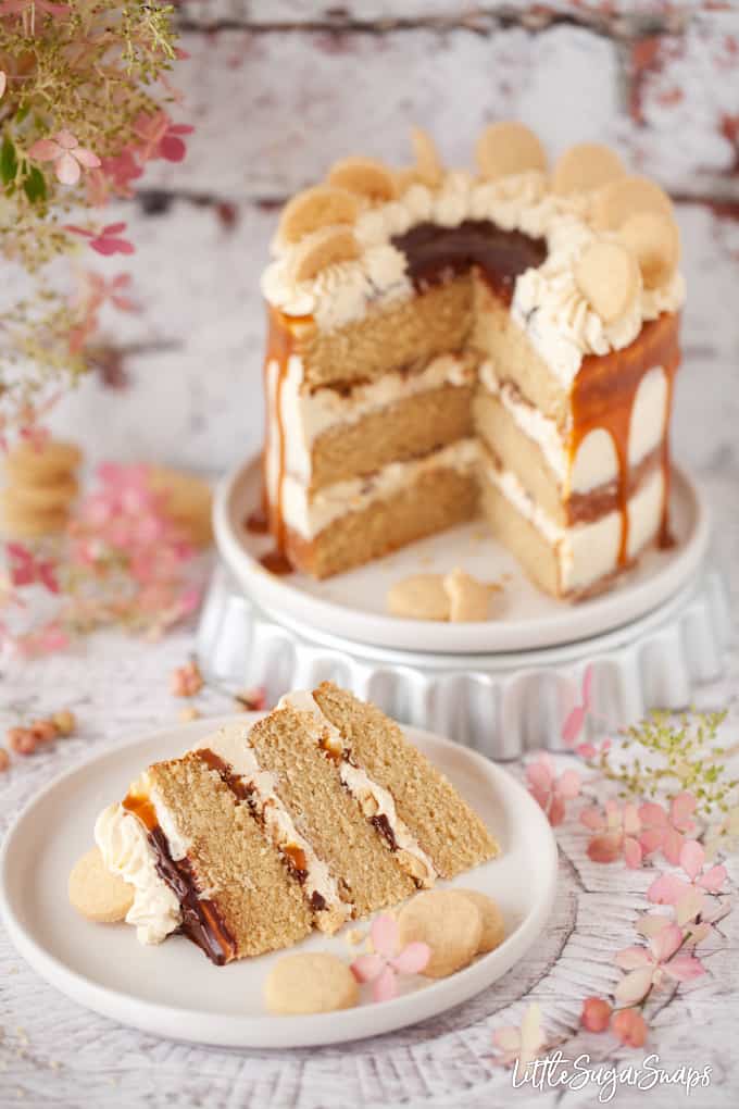 Millionaire Cake with caramel and chocolate sauce with a slice cut out.