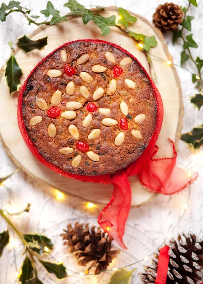 Last Minute Christmas Cake tied with a red ribbon and garnished with almonds and cherries