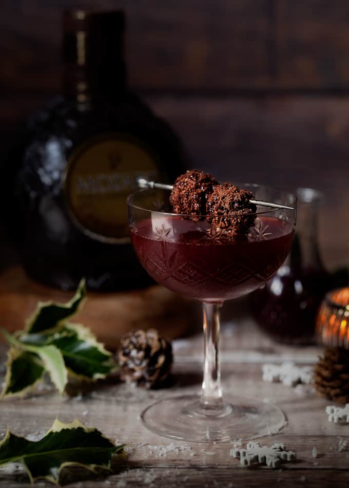 chocolate and bourbon blackberry cocktail with blackberries covered in chocolate flakes