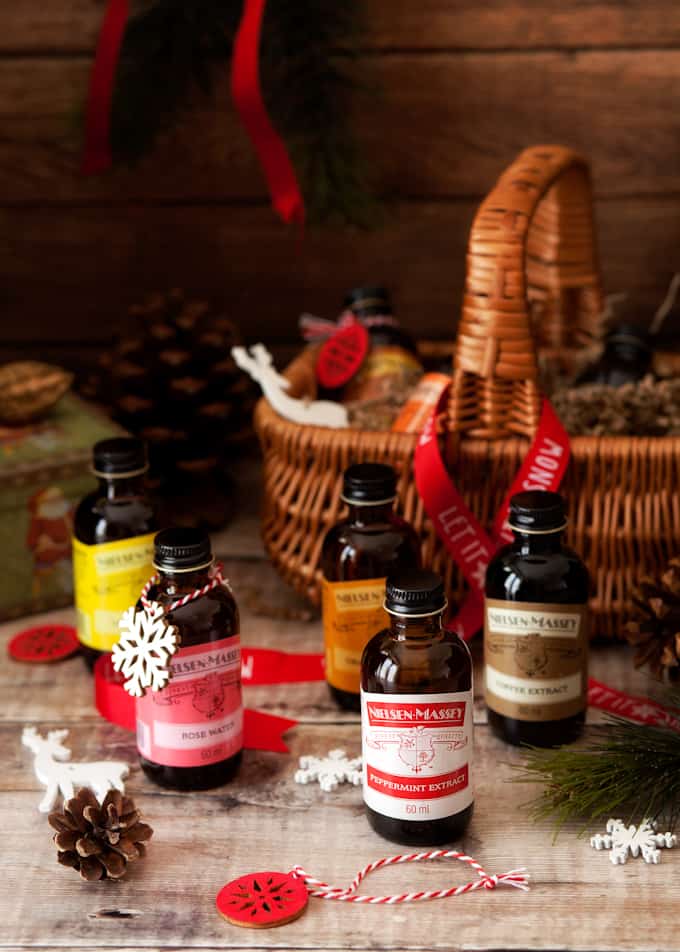 Bottles of flavour extracts in front of a wicker basket.