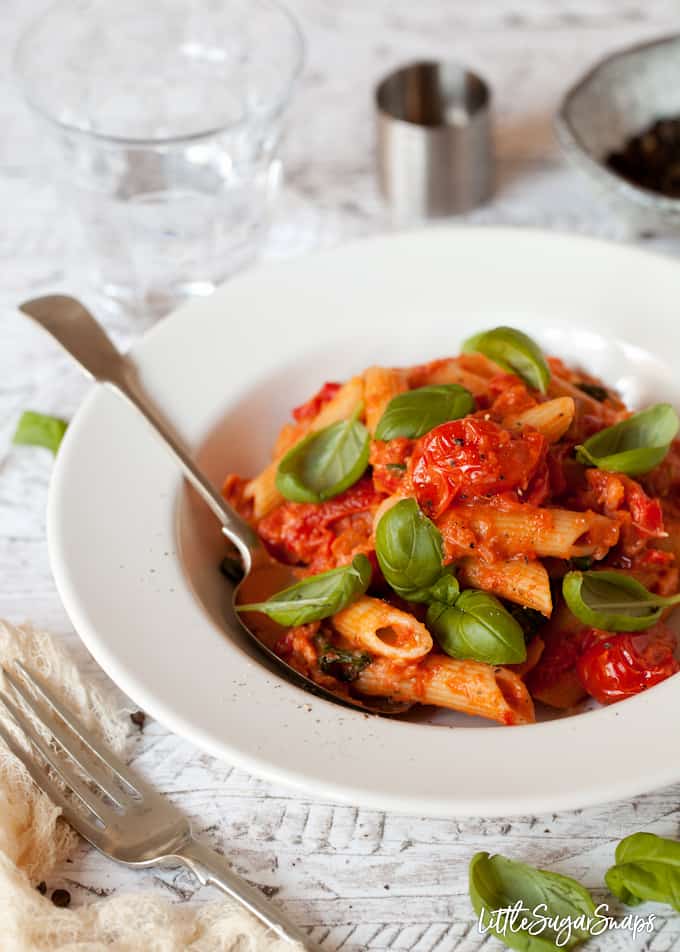 Penne Alla Vodka with smoked salmon and peppers in a white bowl.