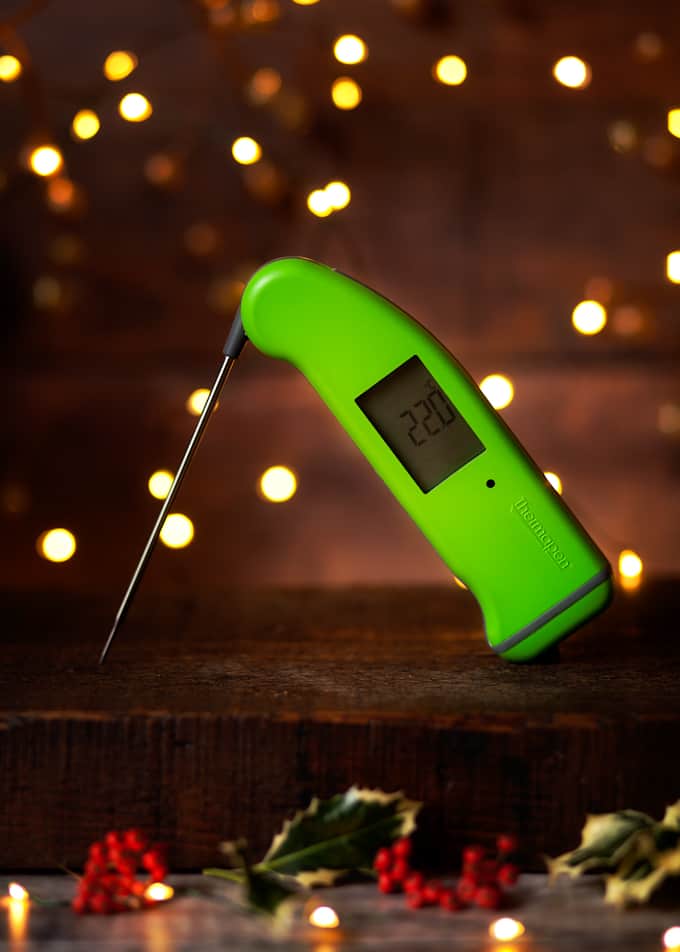 Green Thermapen Professional with festive fairy lights and holly.