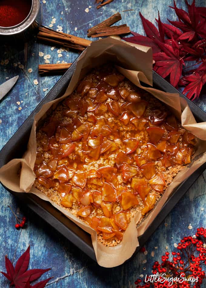 Toffee apple sauce spread over a flapjack base in a baking tin