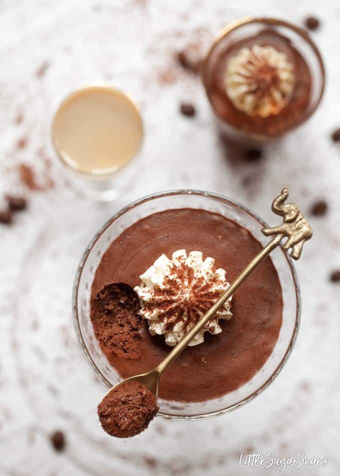 Baileys chocolate mousse in a cocktail glass topped with whipped cream and chocolate flakes.