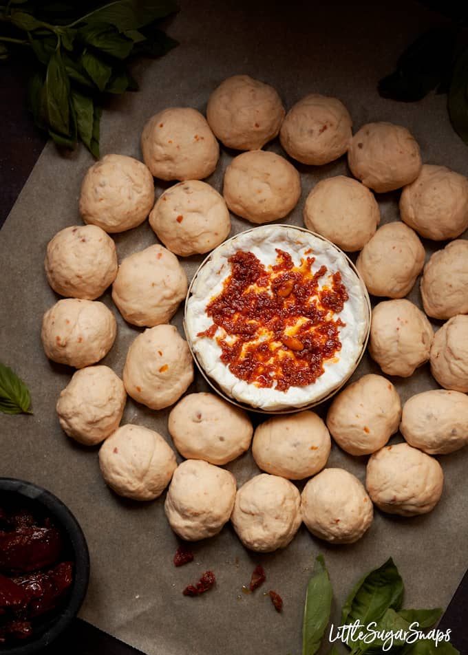 step by step process shot of assembling a dough ball and baked camembert wreath. Ready to bake