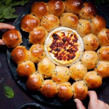 Dough Ball and Baked Camembert Wreath being pulled apart by 2 people