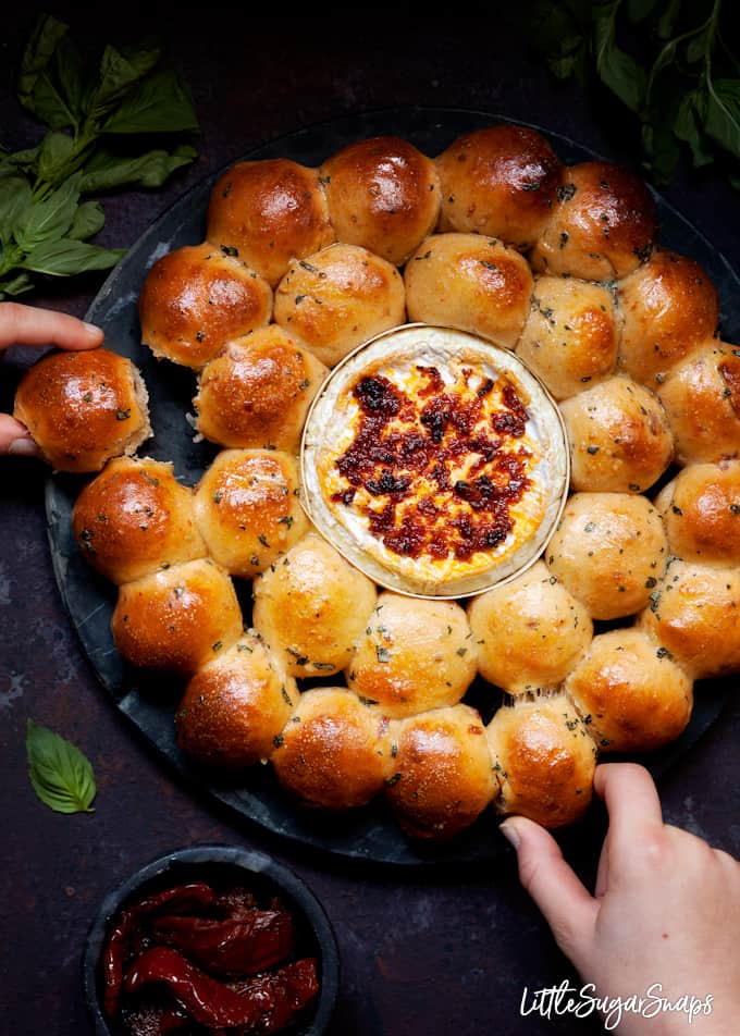 Dough Ball and Baked Camembert Wreath being pulled apart by 2 people