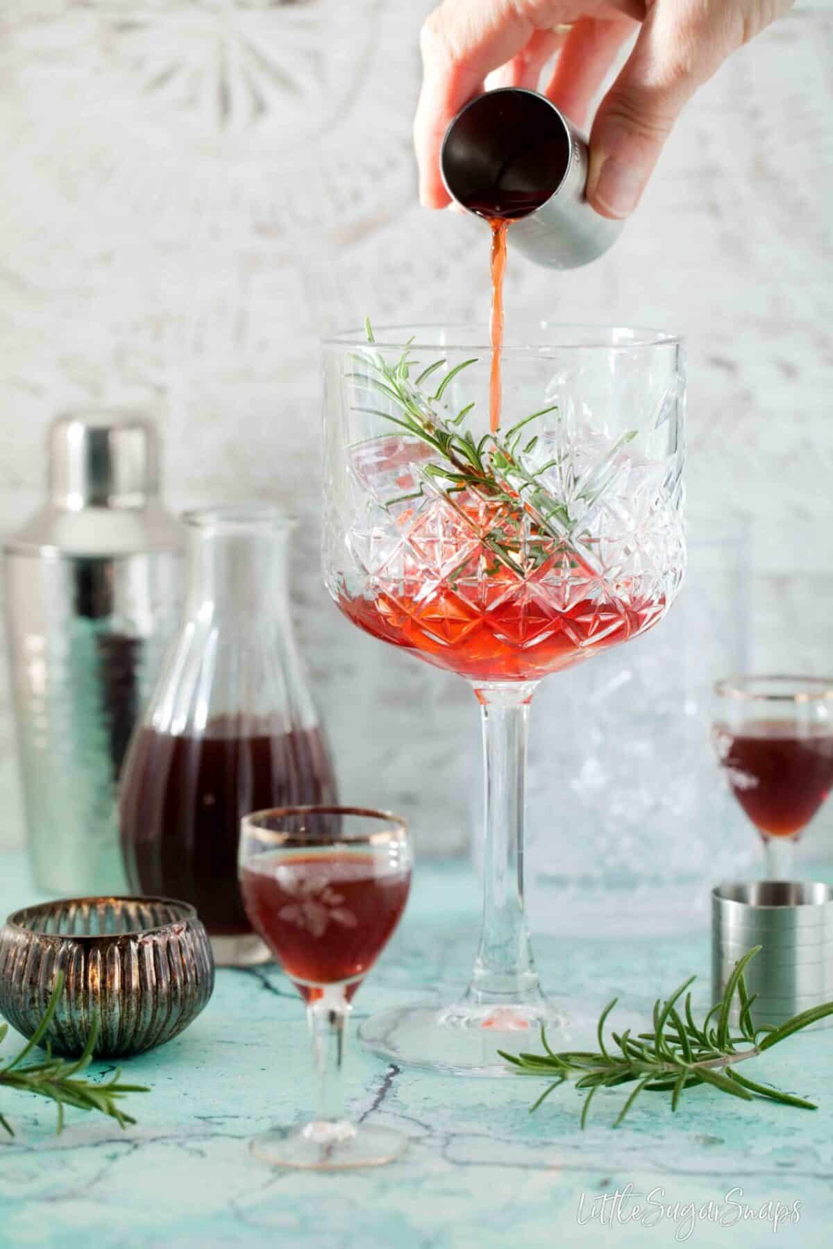 pouring aperol into a copa glass