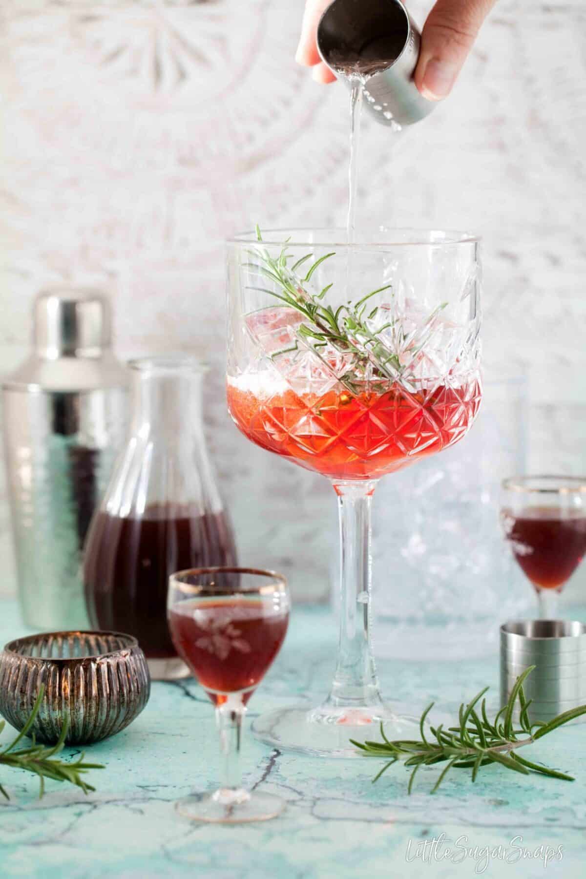 pouring club soda from a can into a copa glass