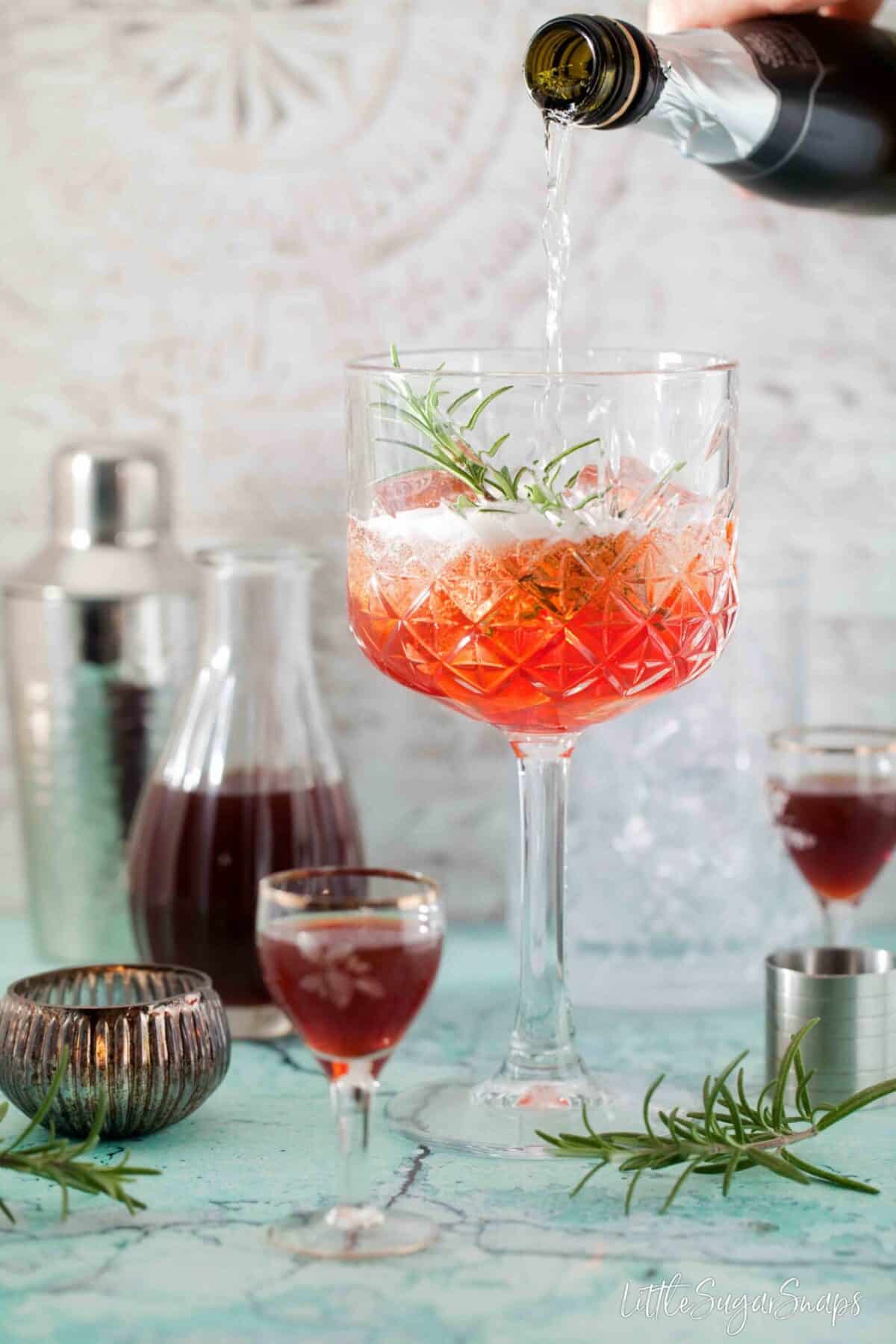 pouring prosecco into a copa glass