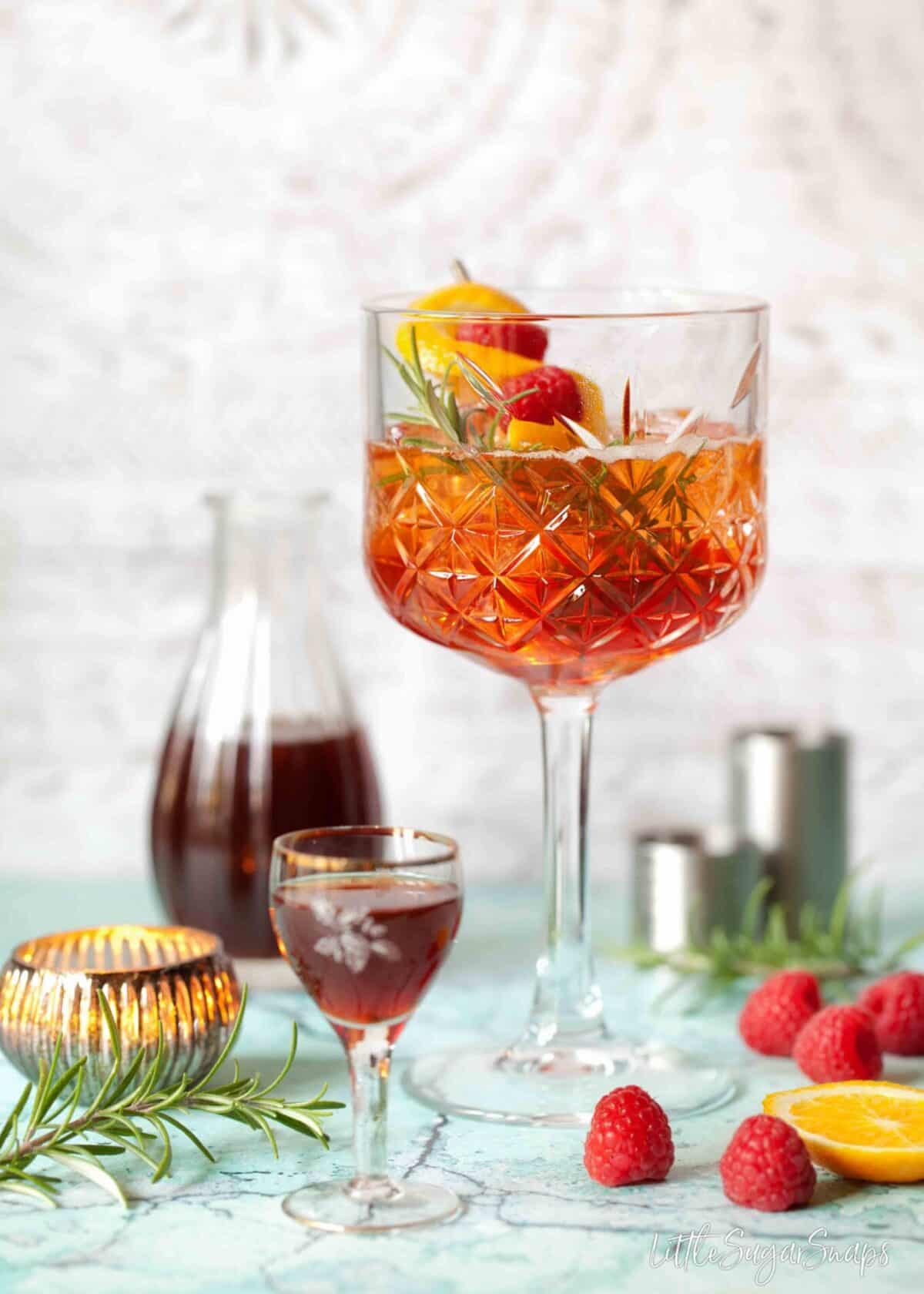 A winter version of aperol spritz with sloe gin and rosemary