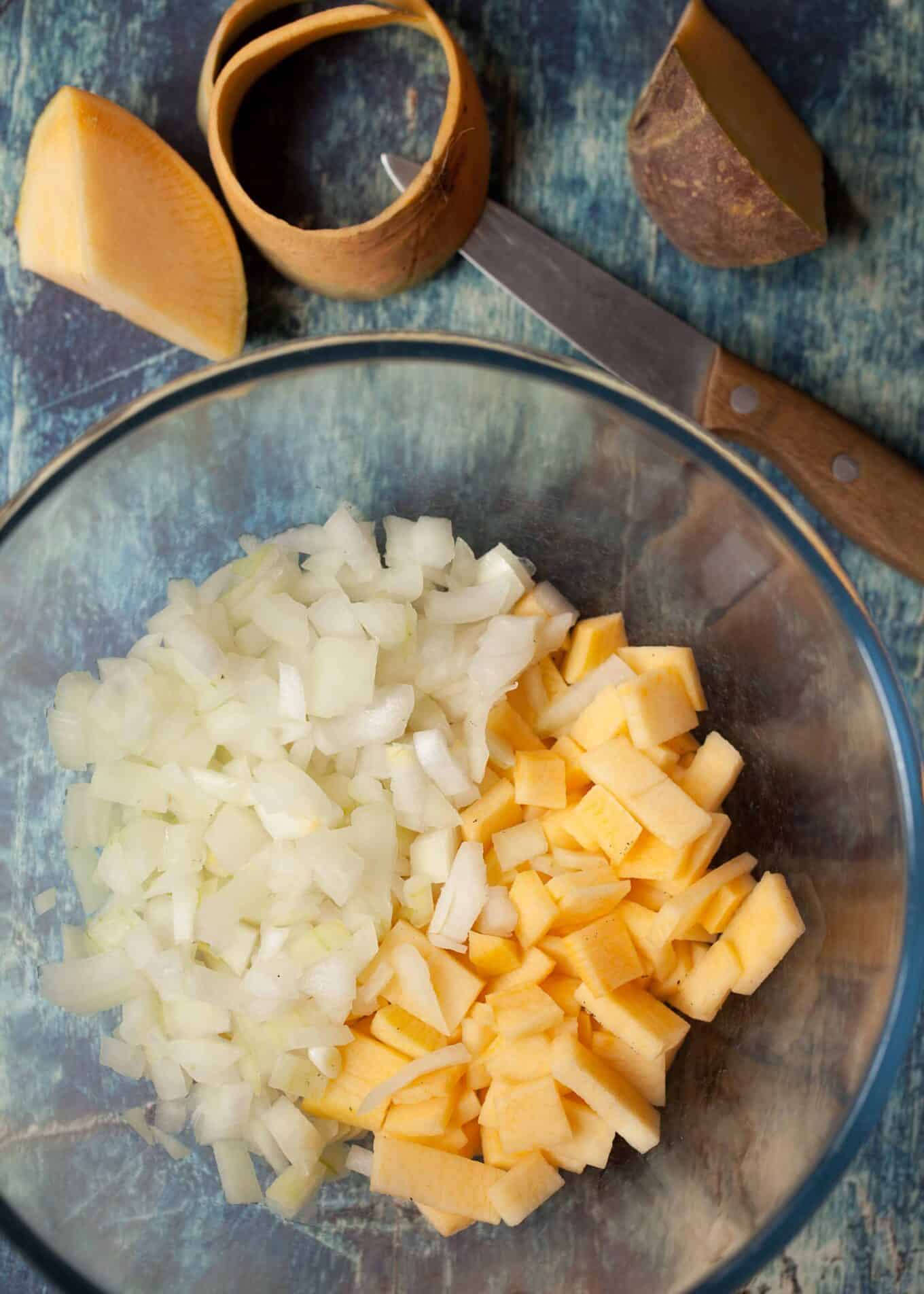 sliced swede and diced onion in a bowl