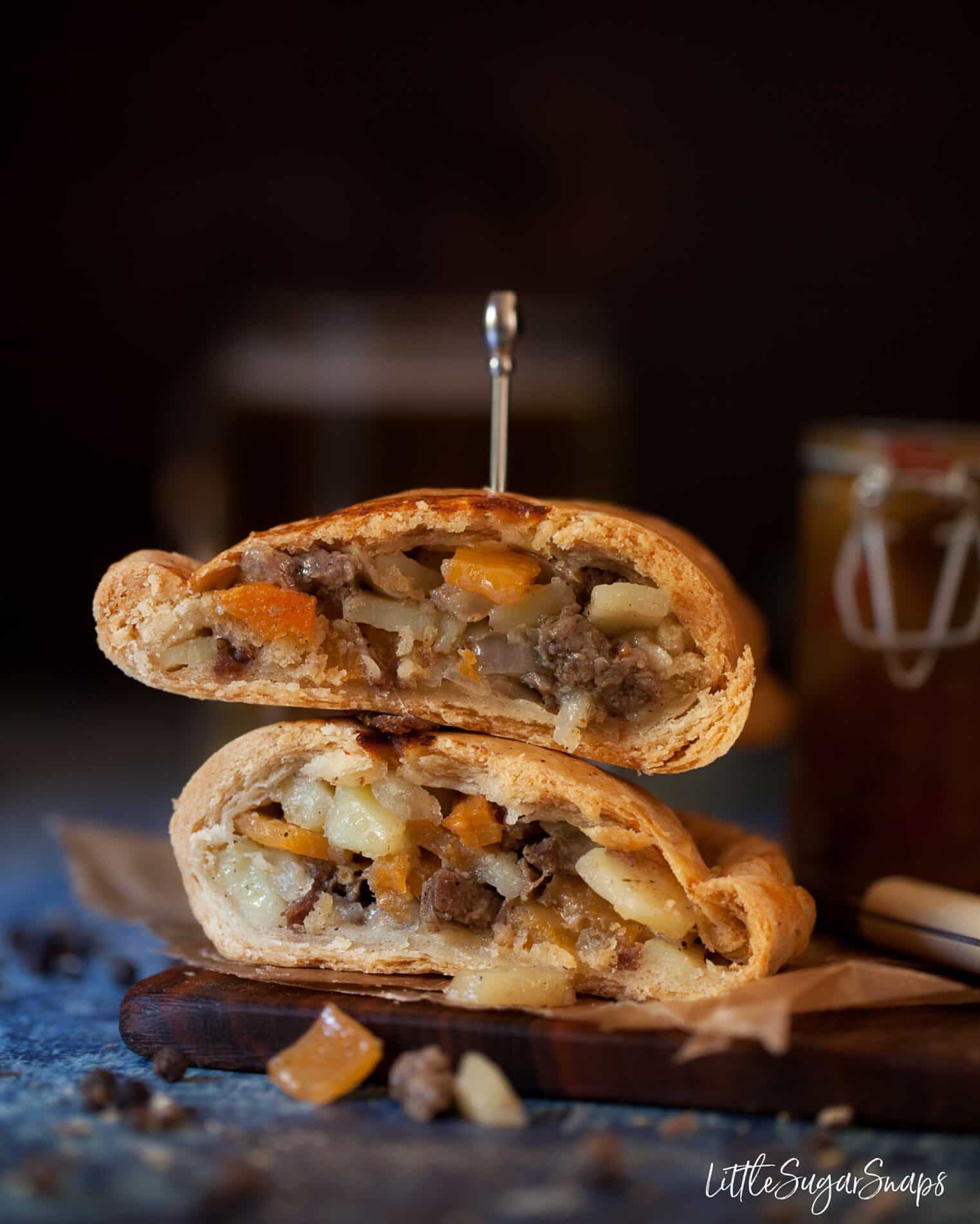 Traditional Cornish pasty cut in half and stacked on top of each other.