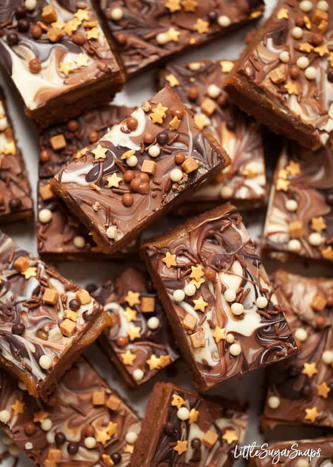 Chocolate Caramel Shortbread Bars topped with marbled chocolate and mixed sprinkles.