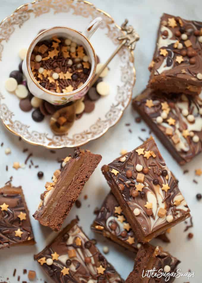 Millionaires shortbread bars with marbled chocolate and mixed sprinkles.