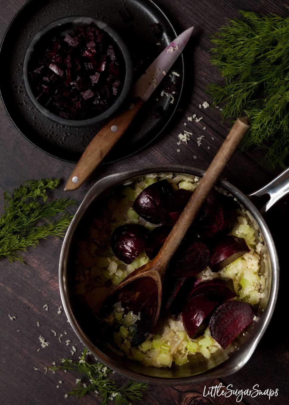 Process image: Making beetroot , celery and onion in a pan