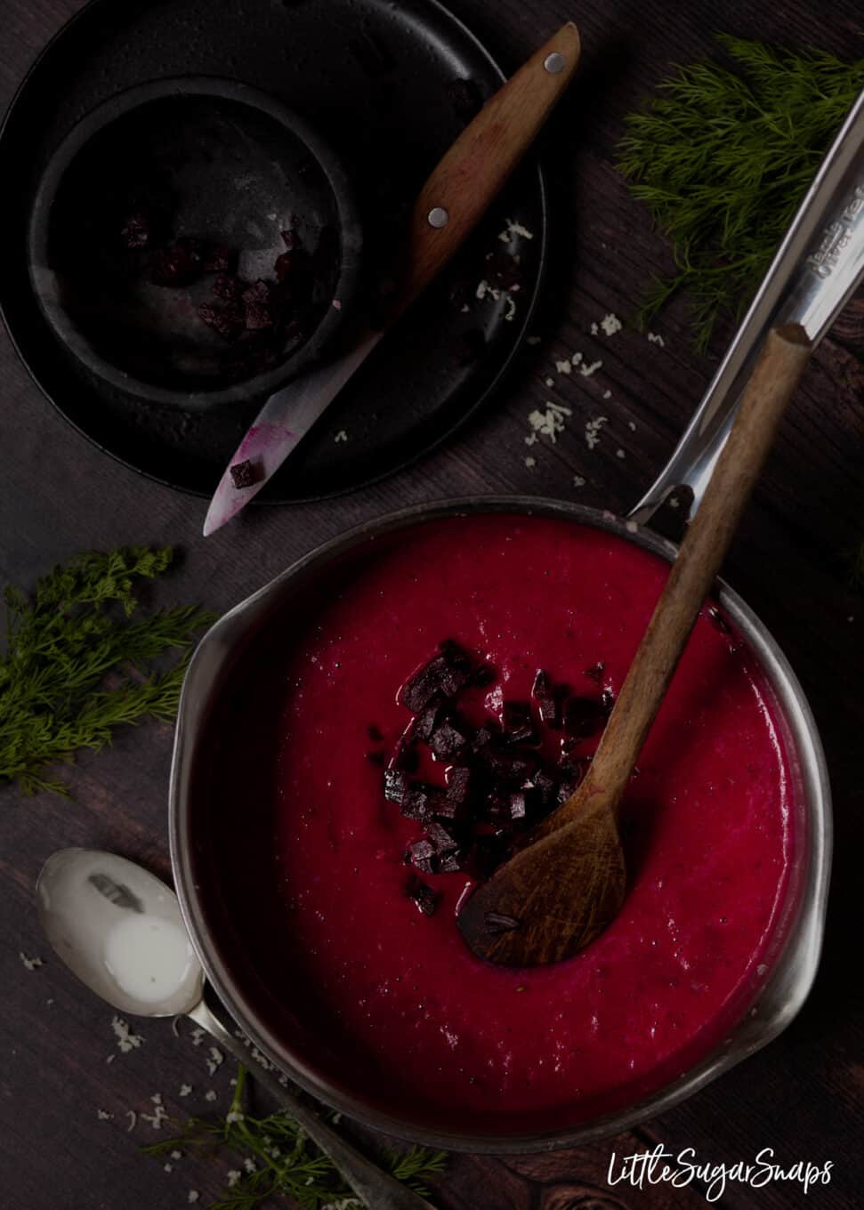 Making beet soup - stirring chunks of beetroot into the soup