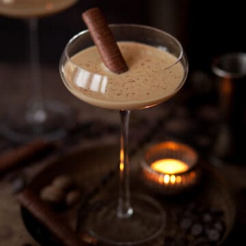 Brandy Alexander cocktail with a chocolate wafer and chocolate flakes to decorate