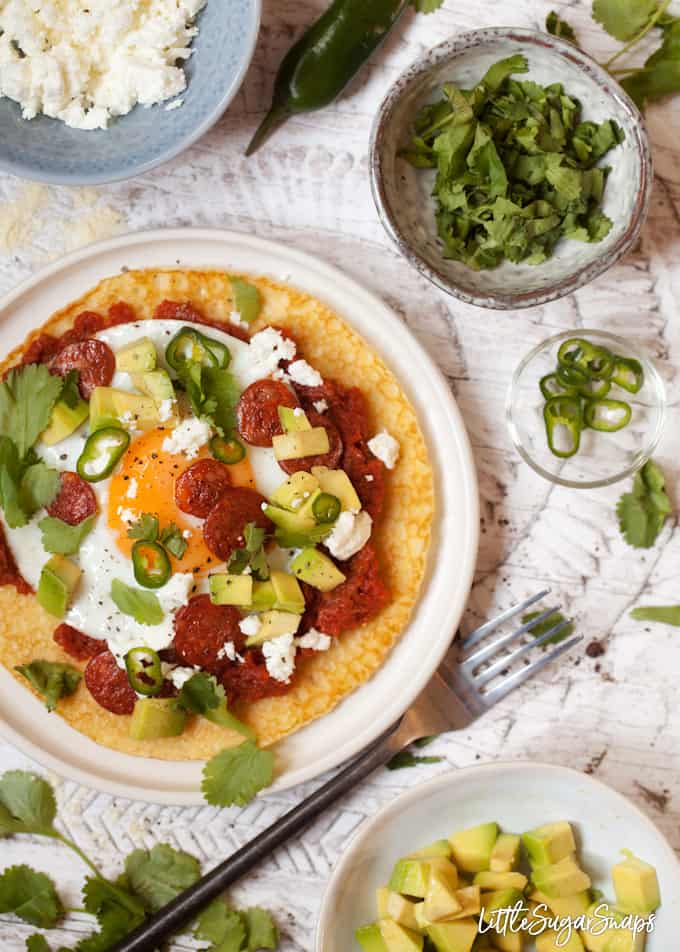 Mexican eggs served on a pancake with avocado, feta, chorizo and chilli toppings.