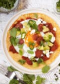 Huevos Rancheros with a cornmeal Crepe with spicy tomato sauce, a fried egg, green chillis and coriander plus chorizo, feta cheese and avocado chunks