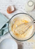 Making batter for cornmeal crepes: whisking ingredients in a bowl