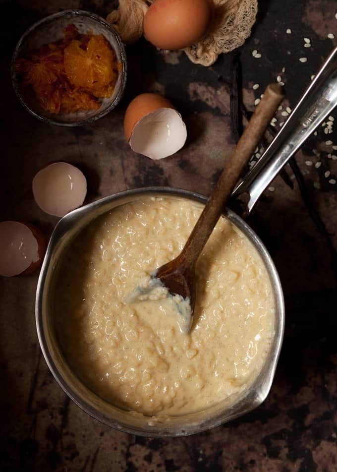 Stovetop rice pudding in a saucepan. Egg shells are next to it