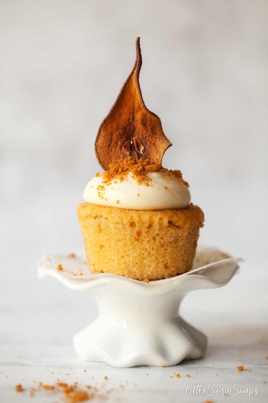 Cupcake decorated with oven dried pear and biscuit crumbs
