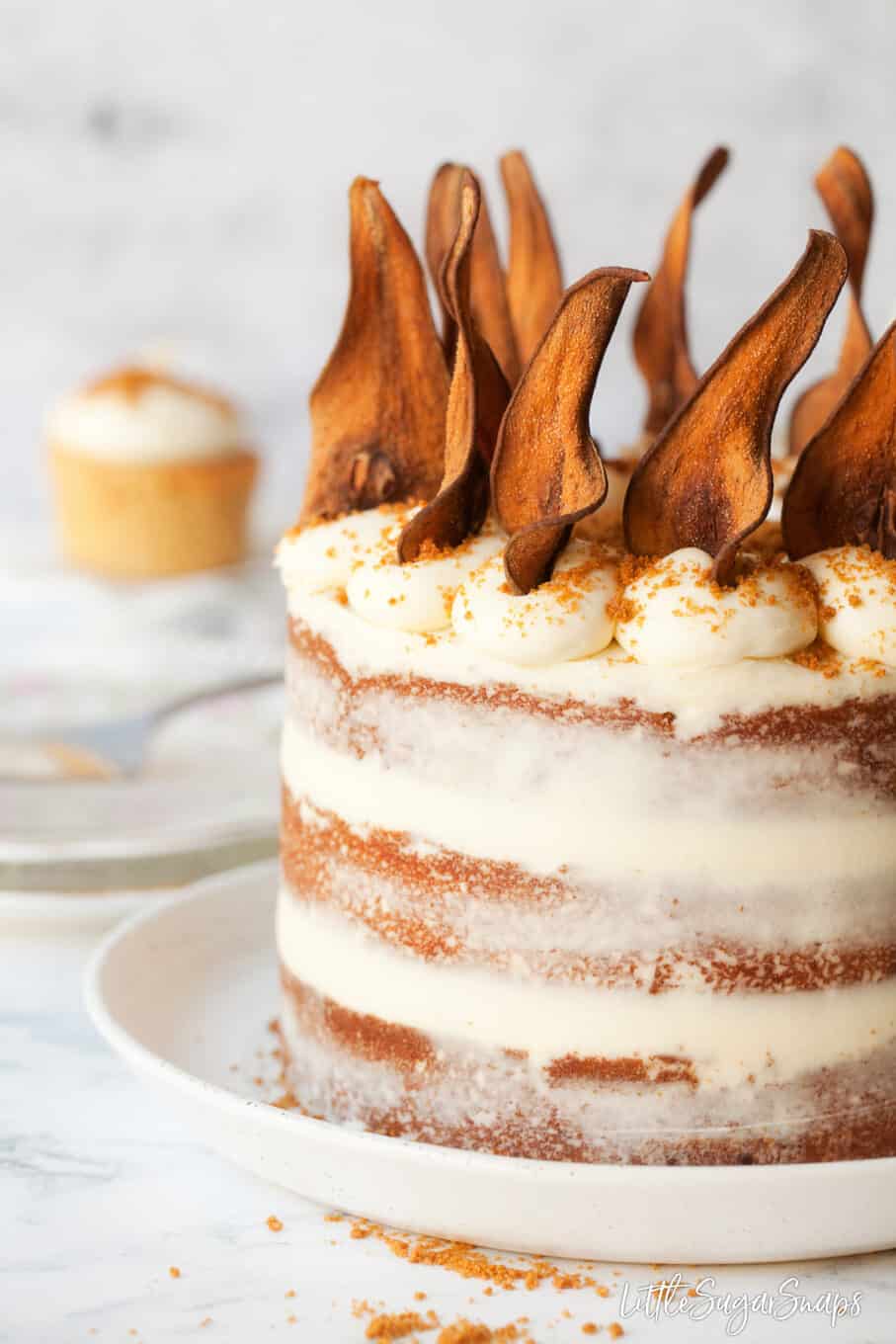 Close up of pear cake recipe with white chocolate frosting and pear wafers