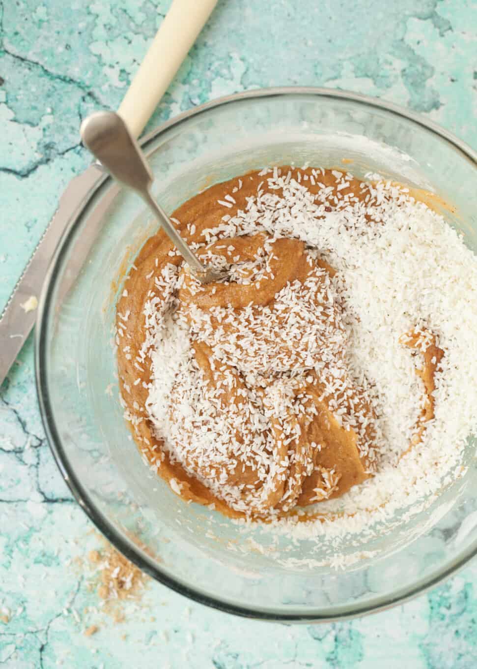 Step by Step process shot: mixing desiccated coconut into batter