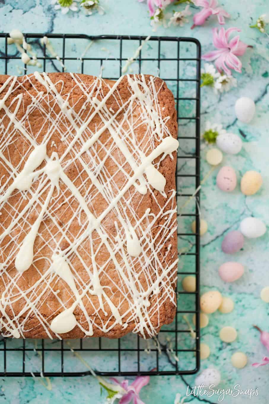 Brown butter blondies with coconut decorated with white chocolate drizzle. 