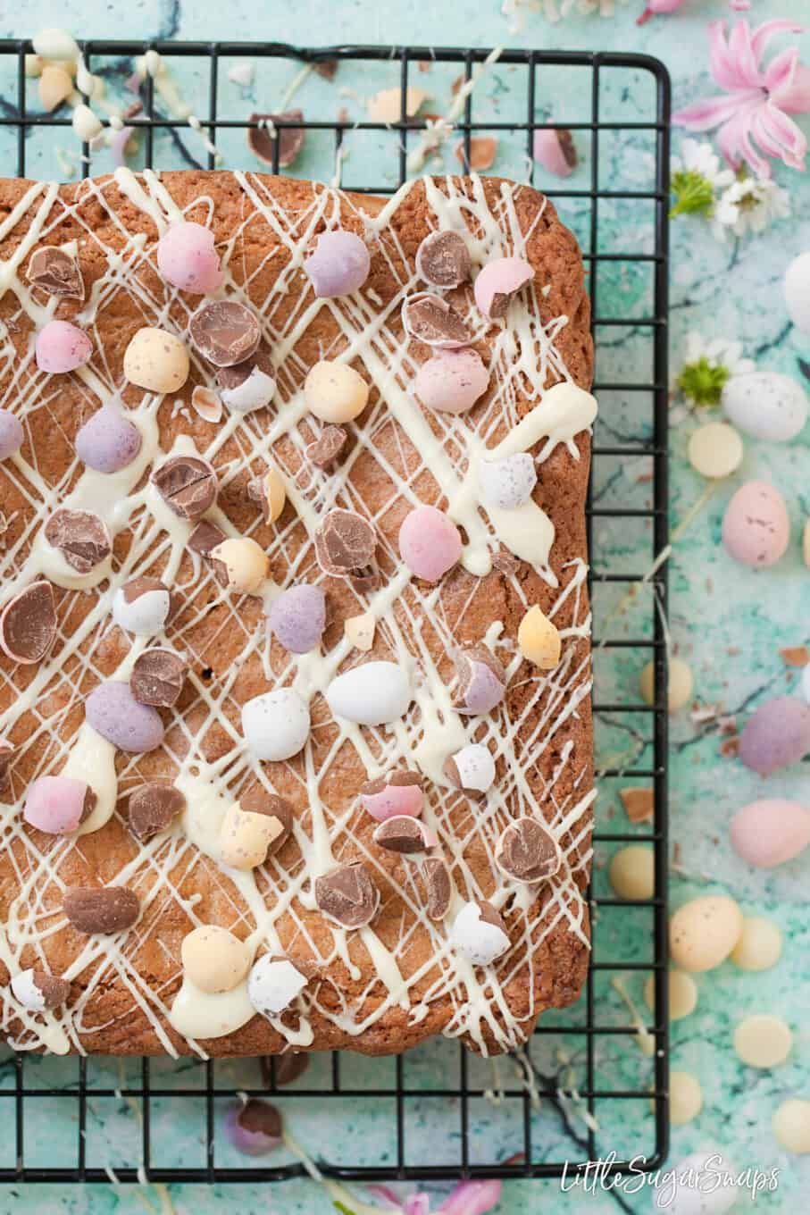 Easter themed Brown butter blondies with coconut on a cooling rack.