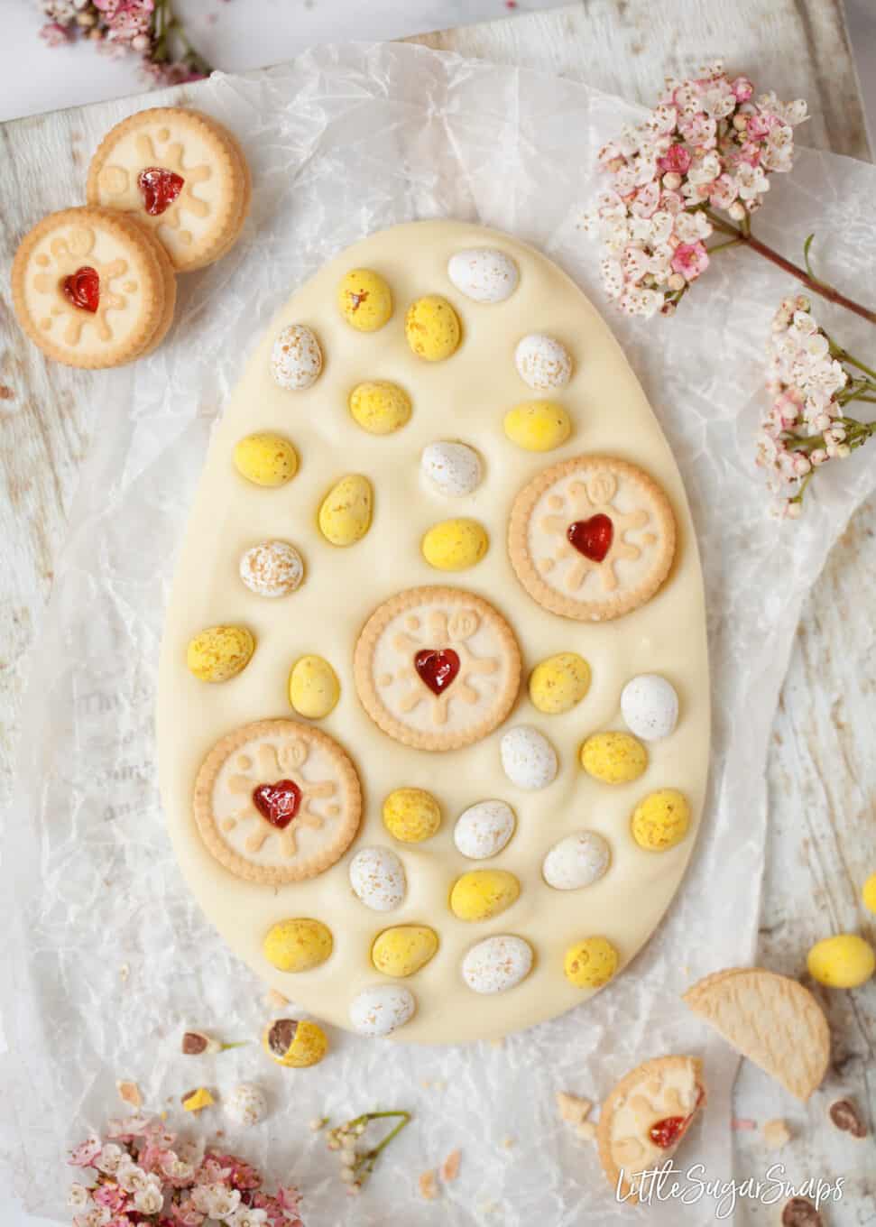 Homemade white chocolate easter egg with jammie dodger biscuits.
