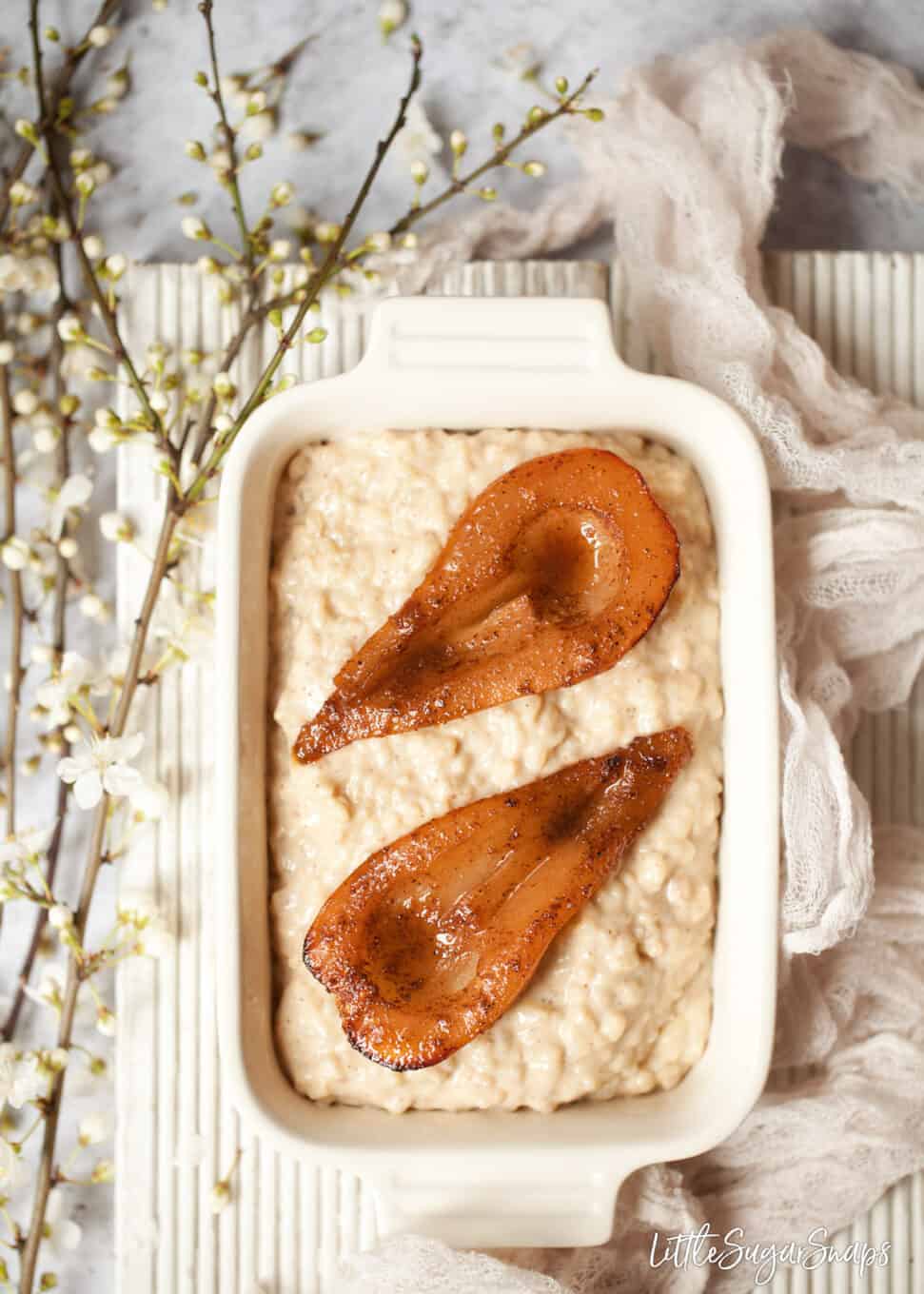 creamy rice dessert with spiced pears in an oblong dish.