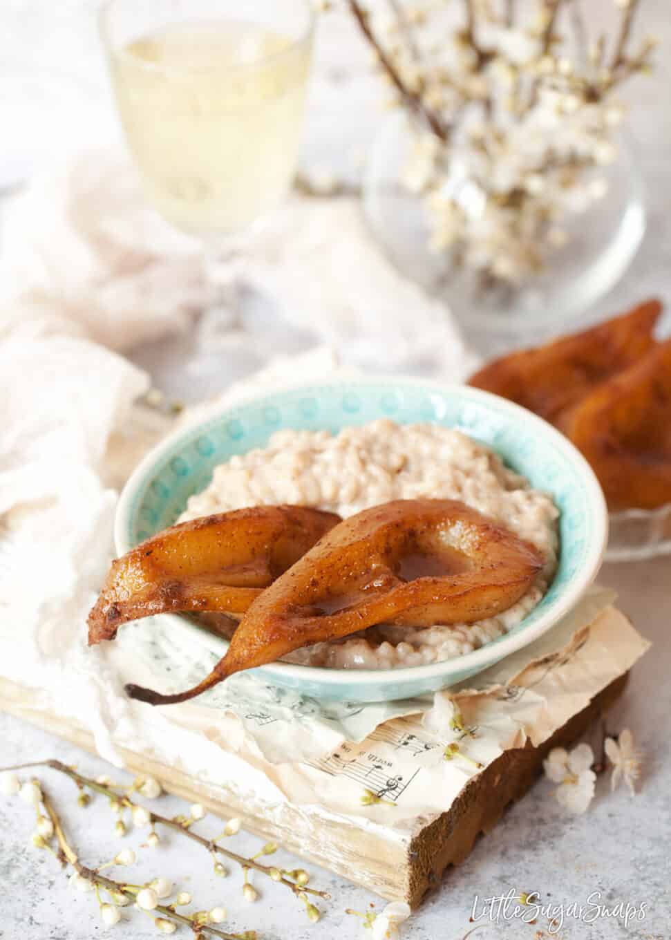 A creamy dessert with spiced roasted pears in a blue bowl