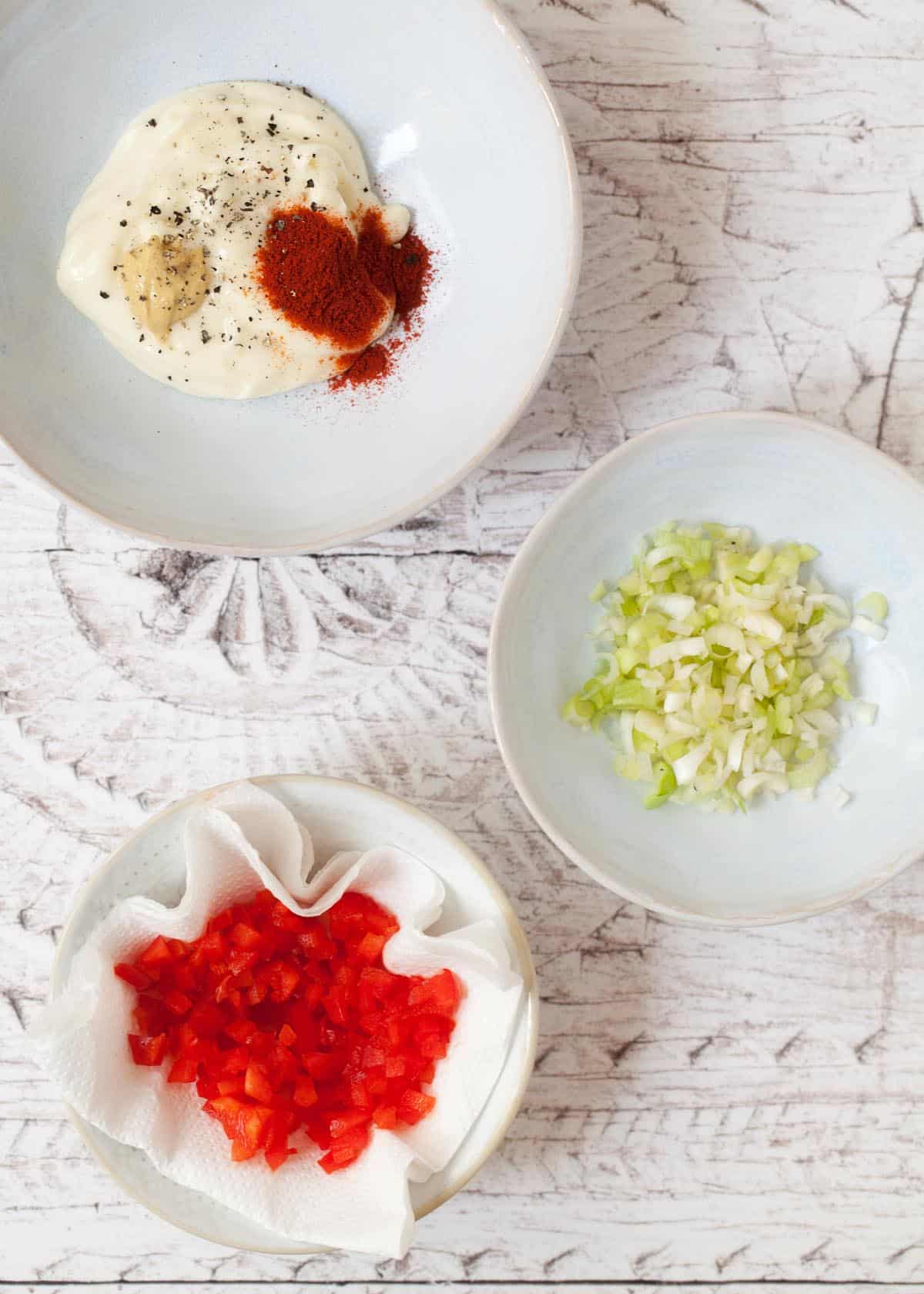 bowls of chopped salad onions, red pepper and mayonnaise