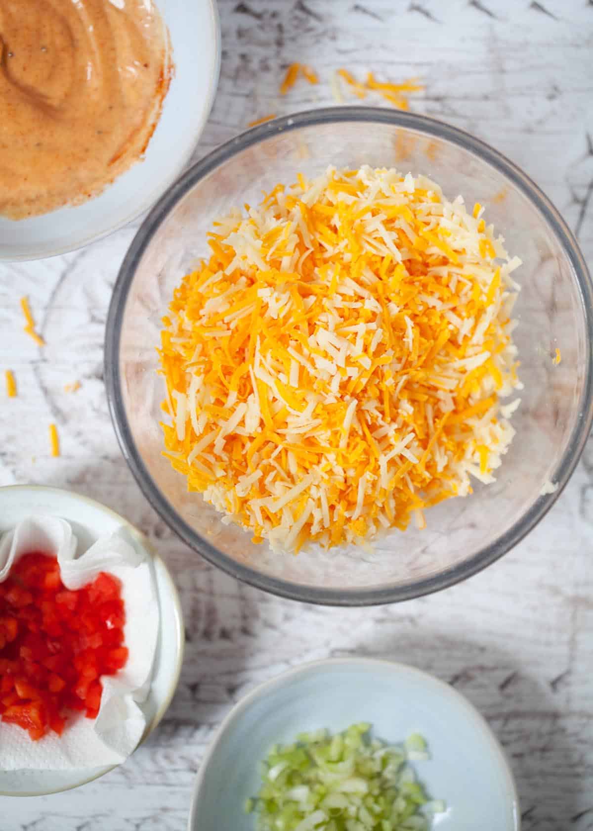 Mixed grated cheese in a bowl.