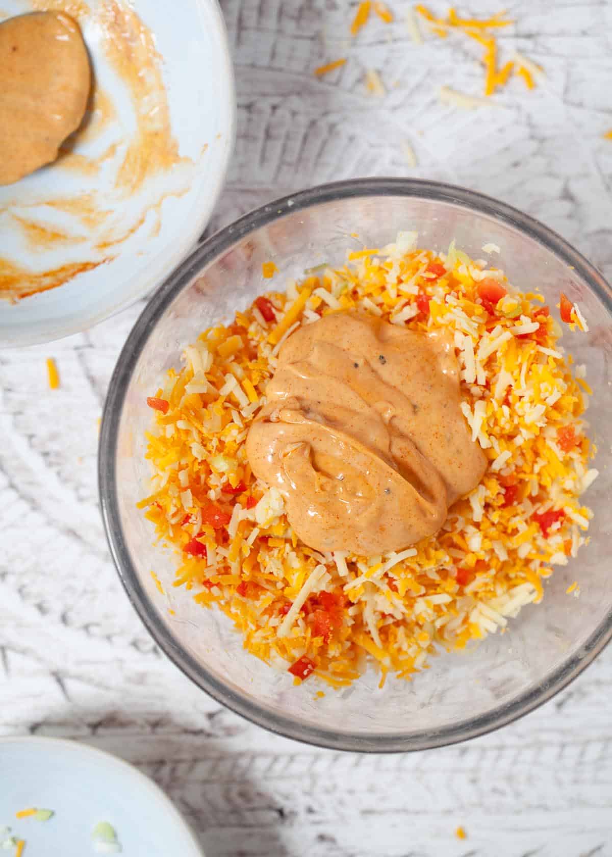 making cheese savoury sandwich filling by mixing grated cheese, red pepper, onion and paprika mayonnaise