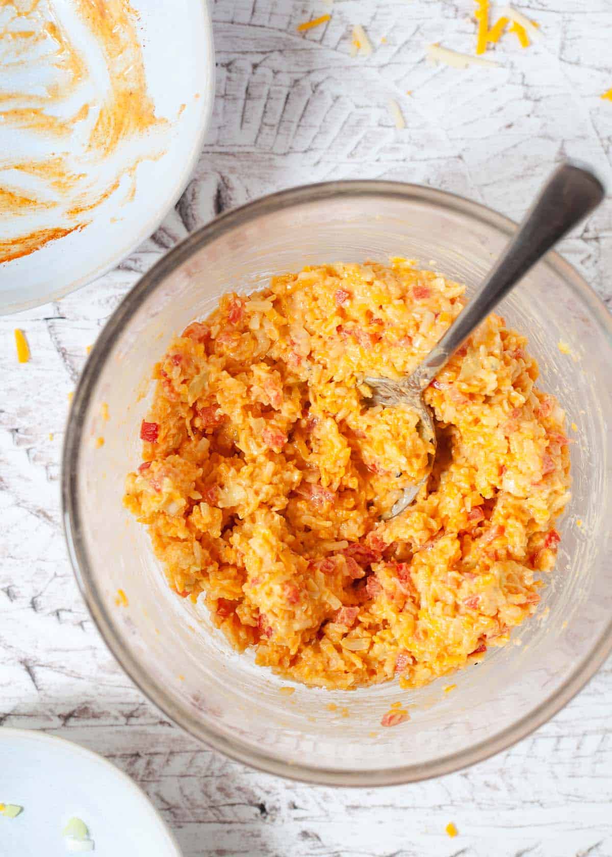 Cheese savoury sandwich filling mixed in a bowl using a spoon.