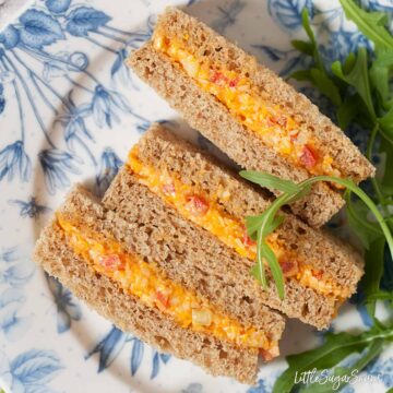 Cheese Savoury Sandwich for Afternoon Tea cut dainty and served on pretty crockery with a rocket leaf garnish