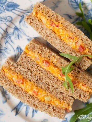 Cheese Savoury Sandwich for Afternoon Tea cut dainty and served on pretty crockery with a rocket leaf garnish