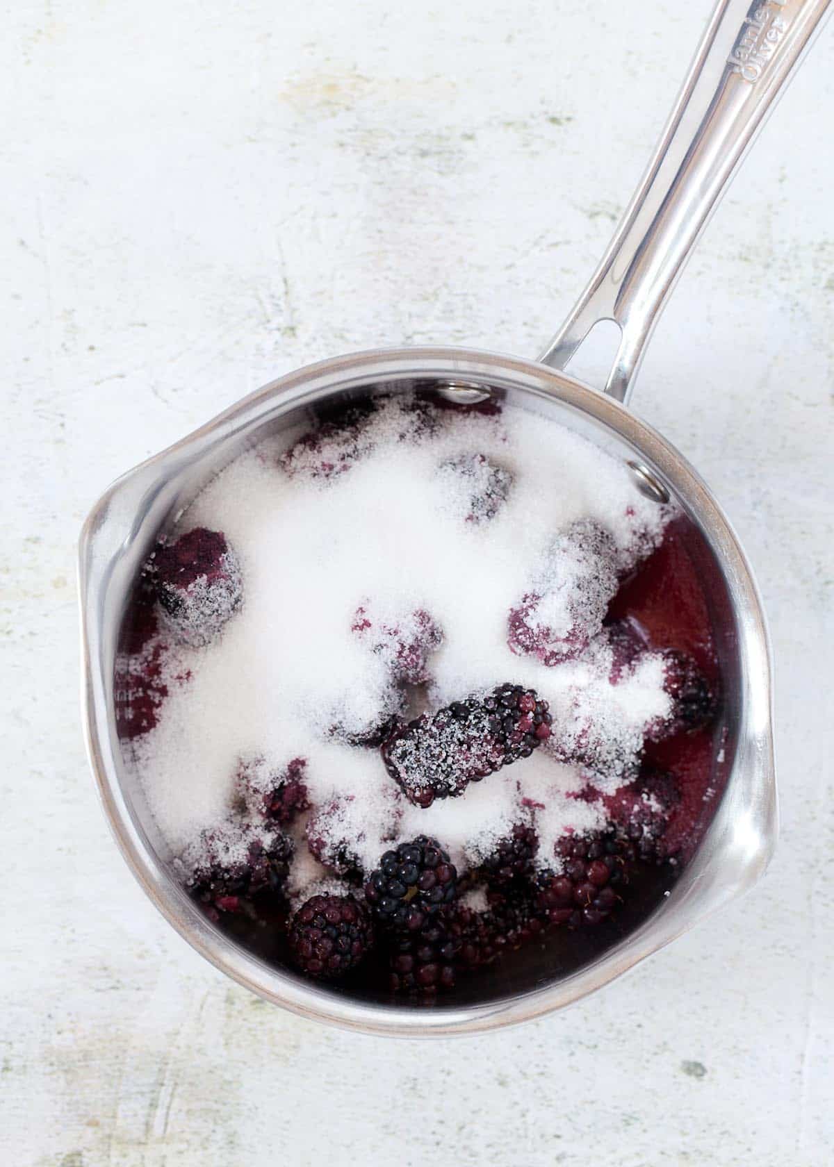 Blackberries and sugar in a saucepan ready to be cooked