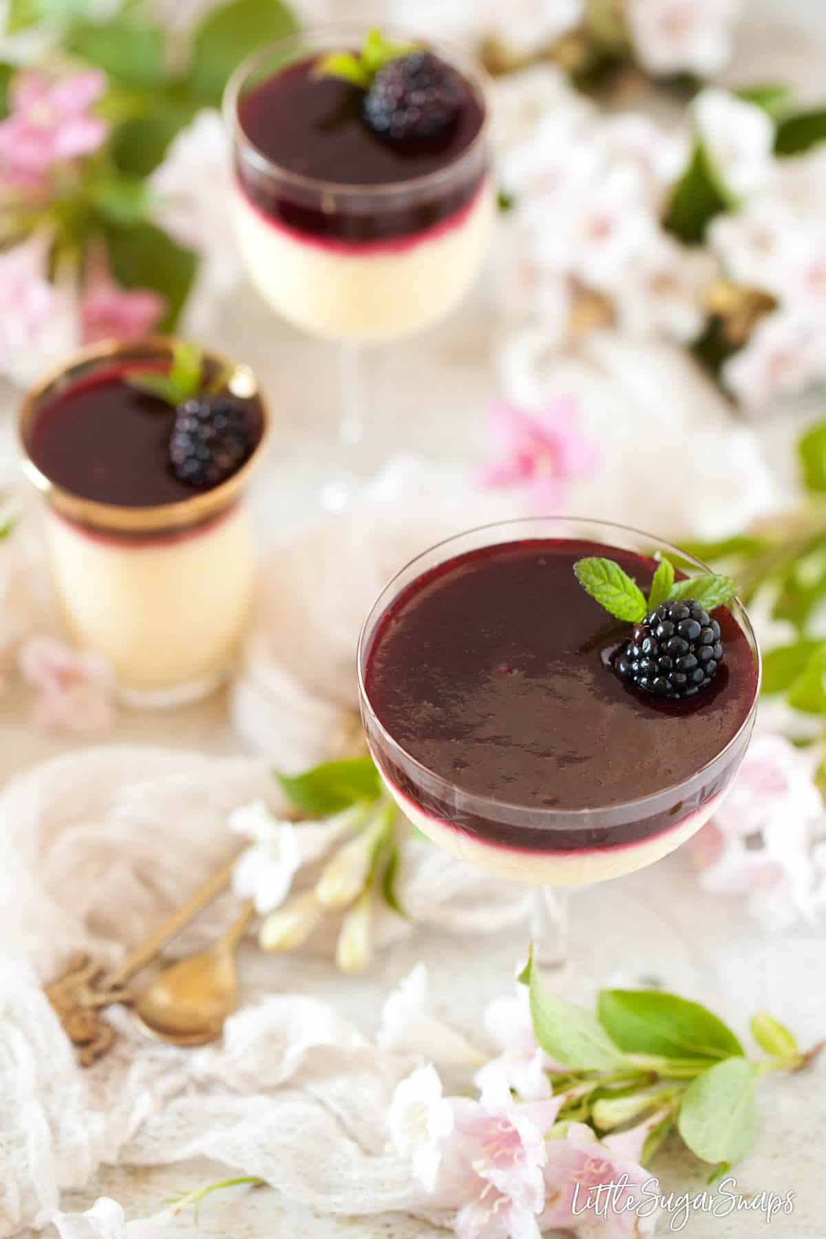 Glasses of lemon posset with blackberry sauce