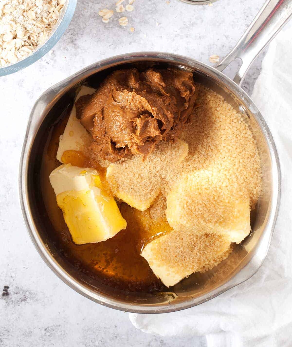 step by step - melting butter, sugar, syrup and cookie butter n a pan