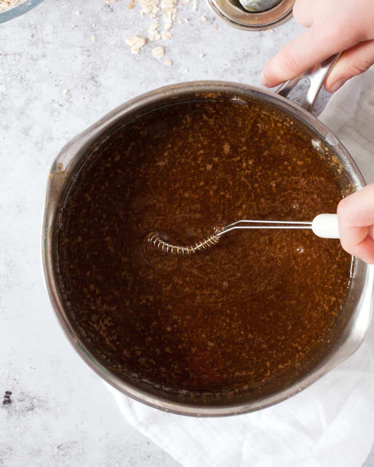 step by step - whisking melted oat bar ingredients in a pan
