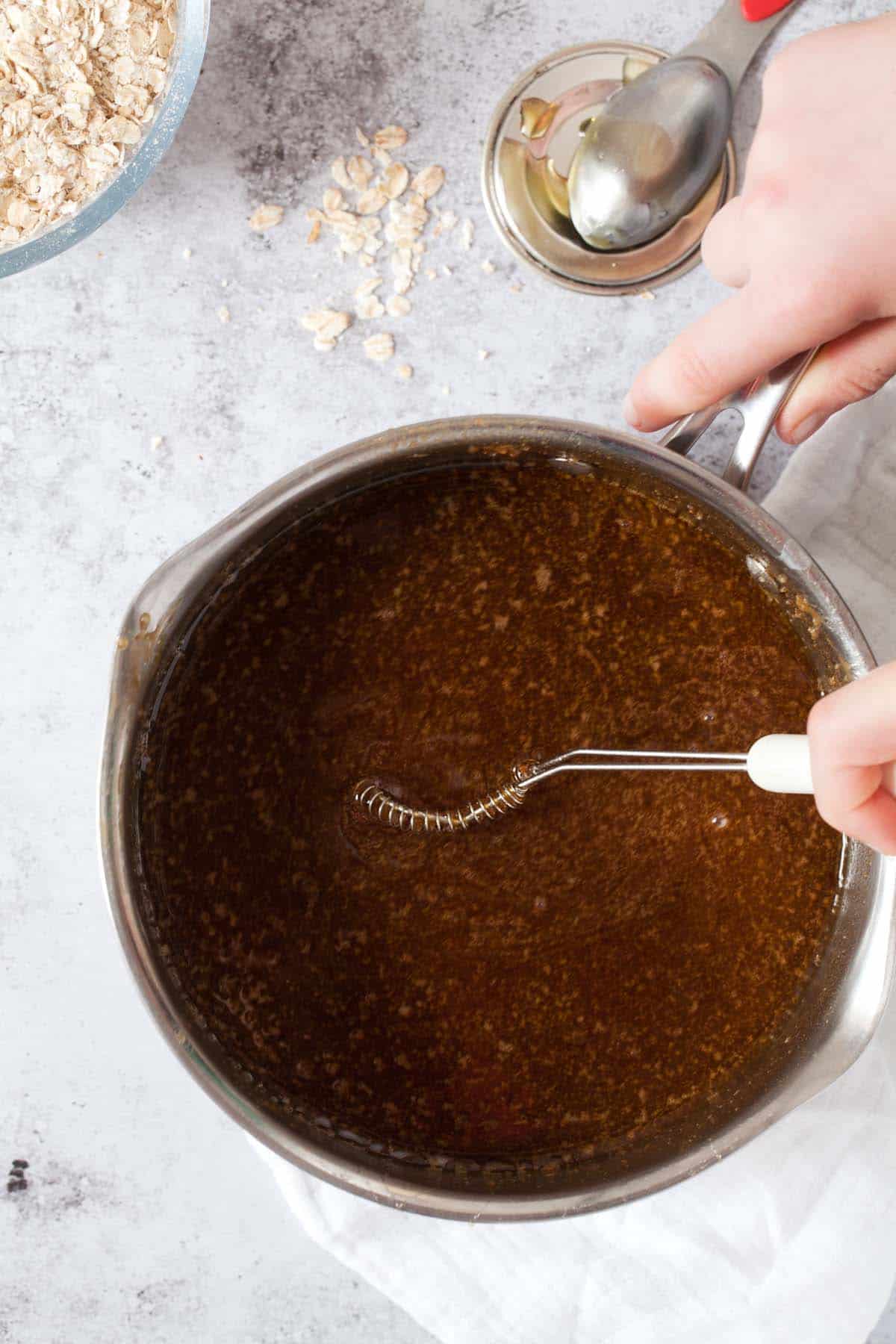 step by step - whisking melted oat bar ingredients in a pan